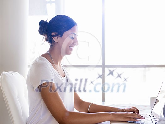 Young woman working with a laptop in office Young woman working with a laptop in office