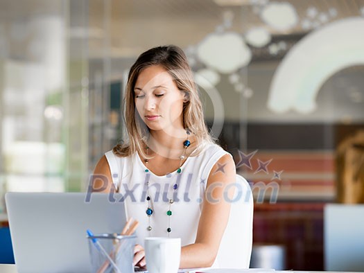Portrait of an attractive young woman using her laptop Portrait of an attractive young woman using her laptop