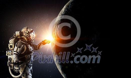 Woman astronaut in space touching planet. Elements of this image furnished by NASA Woman astronaut in space touching planet. Elements of this image furnished by NASA
