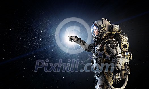 Woman astronaut in space touching planet. Elements of this image furnished by NASA Woman astronaut in space touching planet. Elements of this image furnished by NASA