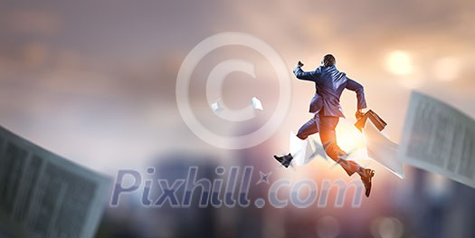 Afroamerican businessman walking with suitcase in hand. Mixed media Afroamerican businessman walking with suitcase in hand. Mixed media