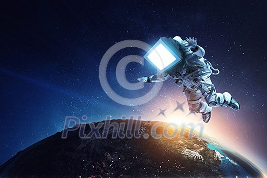 Astronaut with vintage TV head at spacewalk on planet orbit. Mixed media. Astronaut with vintage TV head at spacewalk on planet orbit. Mixed media.