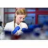 Portrait of a female researcher carrying out research in a chemistry lab (color toned image; shallow DOF)