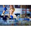 Female researcher carrying out research in a chemistry lab (color toned image; shallow DOF)