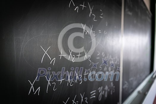 Blackboard with math lesson written on it Blackboard with math lesson written on it