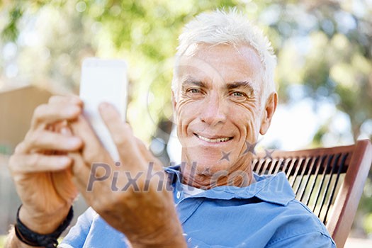 Handsome senior man outdoors using mobile phone Handsome senior man outdoors using mobile phone