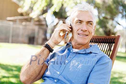 Handsome senior man outdoors using mobile phone Handsome senior man outdoors using mobile phone