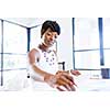 Young beautiful woman sitting at a desk in an office and working on blueprint
