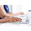 Image of woman's hands typing. Selective focus