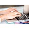 Image of woman's hands typing. Selective focus