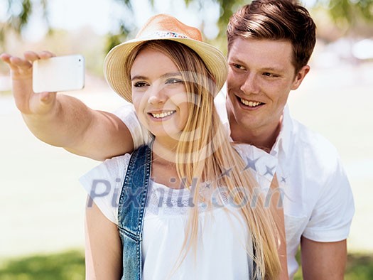 Young happy couple doing selfie in the park Young happy couple doing selfie in the park