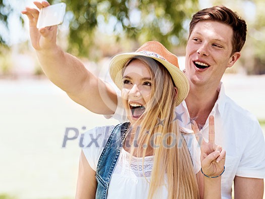 Young happy couple doing selfie in the park Young happy couple doing selfie in the park
