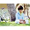 Young woman using tablet in summer park.