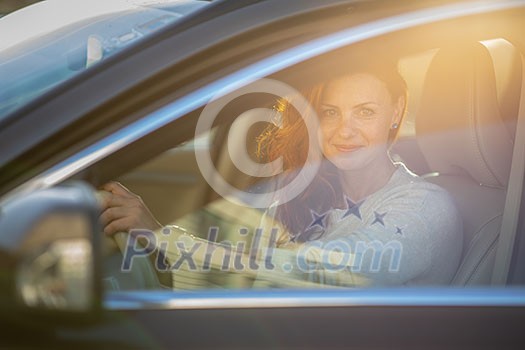 Pretty, young woman driving a car -Invitation to travel. Car rental or vacation. Pretty, young woman driving a car -Invitation to travel. Car rental or vacation.