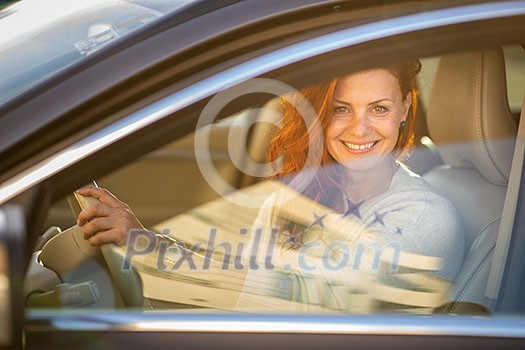 Pretty, young woman driving a car -Invitation to travel. Car rental or vacation. Pretty, young woman driving a car -Invitation to travel. Car rental or vacation.