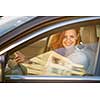 Pretty, young woman  driving a car -Invitation to travel. Car rental or vacation.