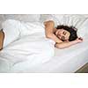 Beautiful young woman sleeping on bed at bedroom