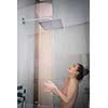 Woman taking a long hot shower washing her hair in a modern design bathroom