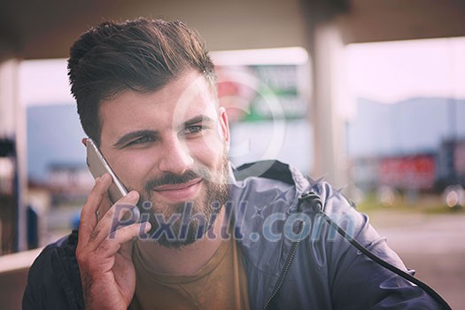 handsome young casual business man with beard using cell phone and smile outdoor on city street handsome young casual business man with beard using cell phone and smile outdoor on city street