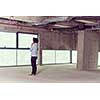 portrait of young male architect on construction site in new startup office