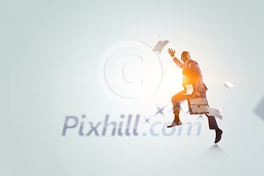 Happy black businessman in blue suit with briefcase running among flying documents with sunshine on white background Happy black businessman in blue suit with briefcase running among flying documents with sunshine on white background
