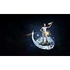 Joyful girl playing with paper airplane against the sky, standing on toy globe, dark space background