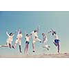 happy people group have fun  run and jump  on beach beautiful sand  beach