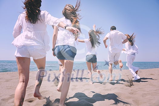 happy people group have fun run and jump on beach beautiful sand beach happy people group have fun run and jump on beach beautiful sand beach