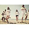 happy people group have fun  run and jump  on beach beautiful sand  beach