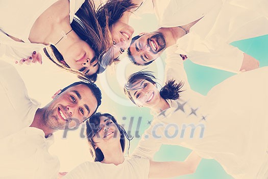 Group of happy young people in circle at beach  have fun and smile