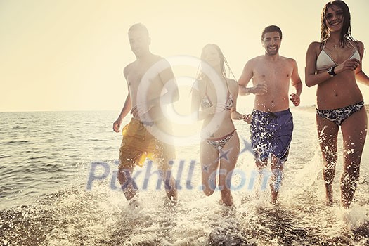 happy people group have fun  run and jump  on beach beautiful sand  beach