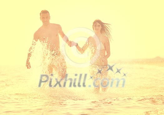 happy young couple have romantic time on beach at sunset happy young couple have romantic time on beach at sunset