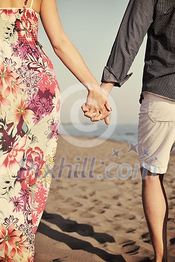 couple on beach with travel bag representing freedom and funy honeymoon concept couple on beach with travel bag representing freedom and funy honeymoon concept