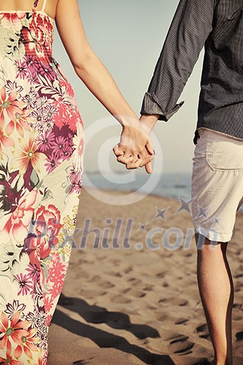 couple on beach with travel bag representing freedom and funy honeymoon concept