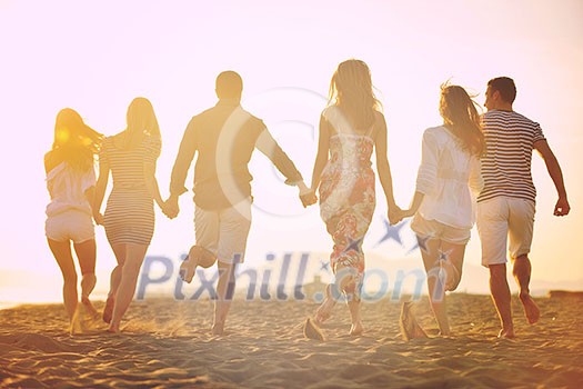 happy young people group have fun run and jump on beach beautiful sand beach happy young people group have fun run and jump on beach beautiful sand beach