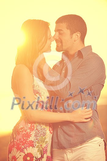 happy young couple have romantic time on beach at sunset happy young couple have romantic time on beach at sunset