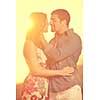 happy young couple have romantic time on beach at sunset