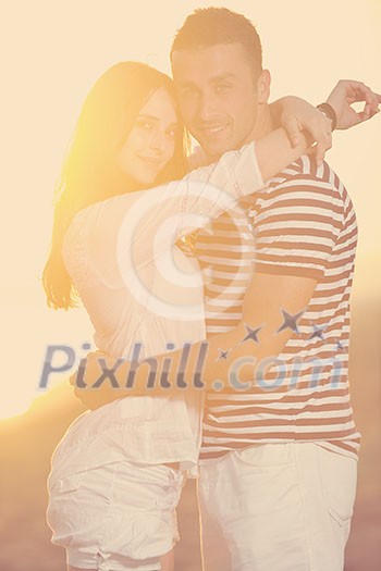 happy young couple have romantic time on beach at sunset happy young couple have romantic time on beach at sunset