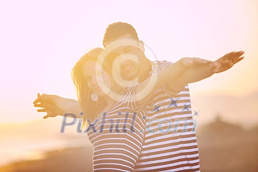 happy young couple have romantic time on beach at sunset happy young couple have romantic time on beach at sunset