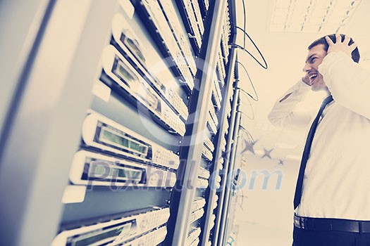 business man in network server room have problems and looking for disaster solution business man in network server room have problems and looking for disaster solution