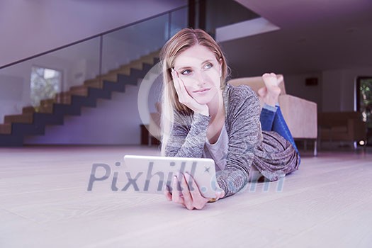 beautiful young women used tablet computer on the floor of her luxury home beautiful young women used tablet computer on the floor of her luxury home