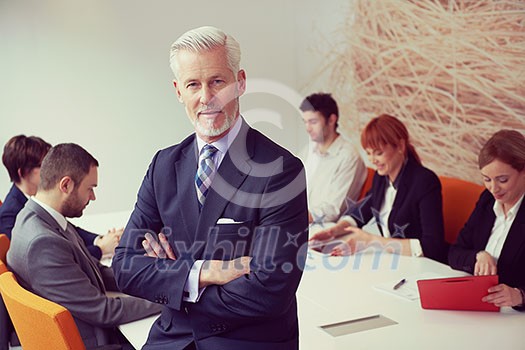 senior businessman with his team at modern office. business people group senior businessman with his team at modern office. business people group