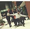 business people group at modern office indoors have fun and push office chair on corridor