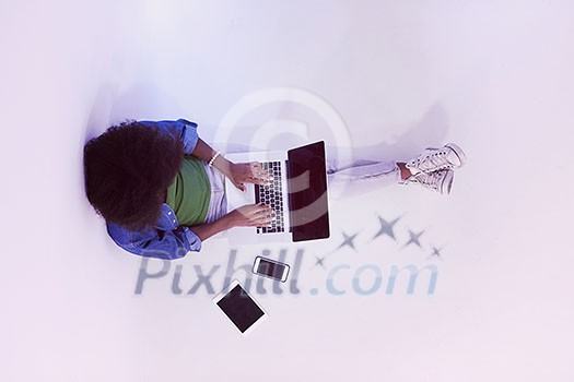Portrait of happy young african american woman sitting on floor with laptop top view Portrait of happy young african american woman sitting on floor with laptop top view
