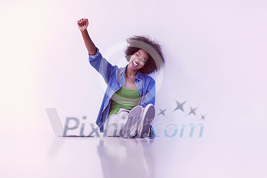 Portrait of happy young african american woman sitting on floor with laptop Portrait of happy young african american woman sitting on floor with laptop