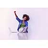 Portrait of happy young african american woman sitting on floor with laptop