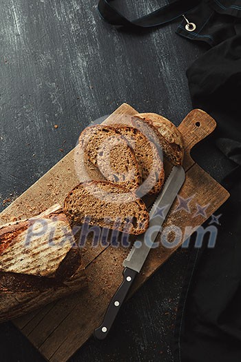 Cut pieces of bread on a cutting board with a knife flat lay Cut pieces of bread on a cutting board with a knife flat lay