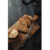 Cut pieces of bread on a cutting board with a knife flat lay