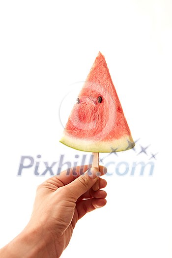 A man's hand holds a juicy piece of watermelon lolly on a white background with space for text. The concept of fruit ice cream A man's hand holds a juicy piece of watermelon lolly on a white background with space for text. The concept of fruit ice cream