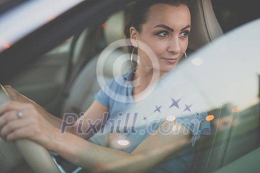Pretty, young woman driving a car -Invitation to travel. Car rental or vacation. Pretty, young woman driving a car -Invitation to travel. Car rental or vacation.